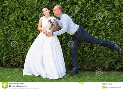 Bride And Groom Kissing Outdoors Wedding Day Of Happy Bridal Couple