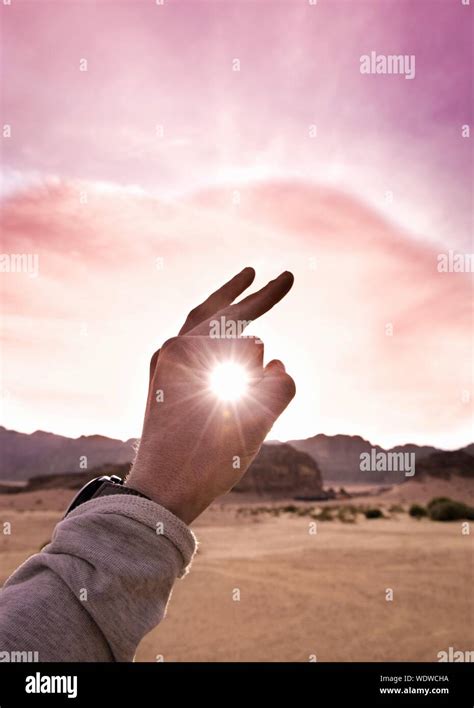 Optical Illusion Hand Holding Sun High Resolution Stock Photography And
