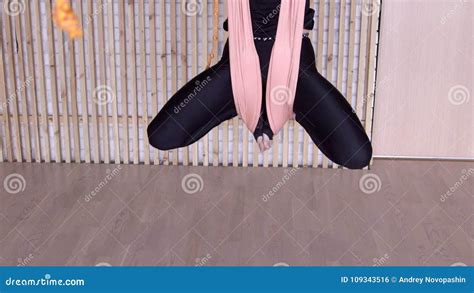female legs bent at the knees hang on the canvas during yoga stock footage video of