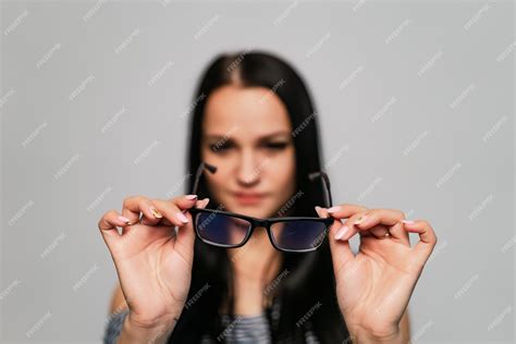 Premium Photo Eyeglasses Closeup Spectacles In Woman S Hands Looking Through Glasses Front