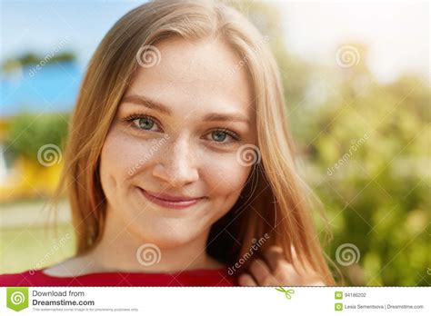 Close Up Portrait Of Fair Haired Woman With Green Alluring Eyes Freckles Smiling Having Dimples