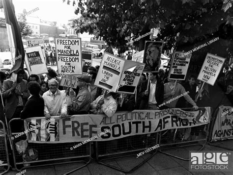 Anti Apartheid Movement Demonstrators Behind Barriers Holding Placards