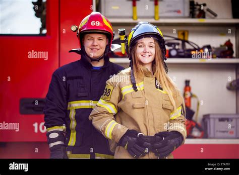 Image Of Firefighters Women And Men In Helmets Looking At Camera Near