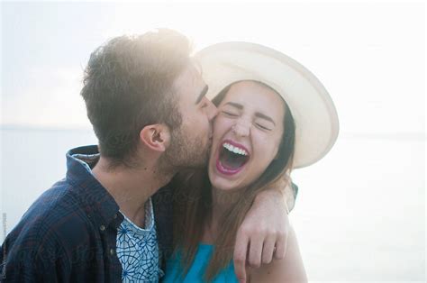 A Young Couple Laughing And Kissing While On Vacation By Stocksy Contributor Chelsea Victoria