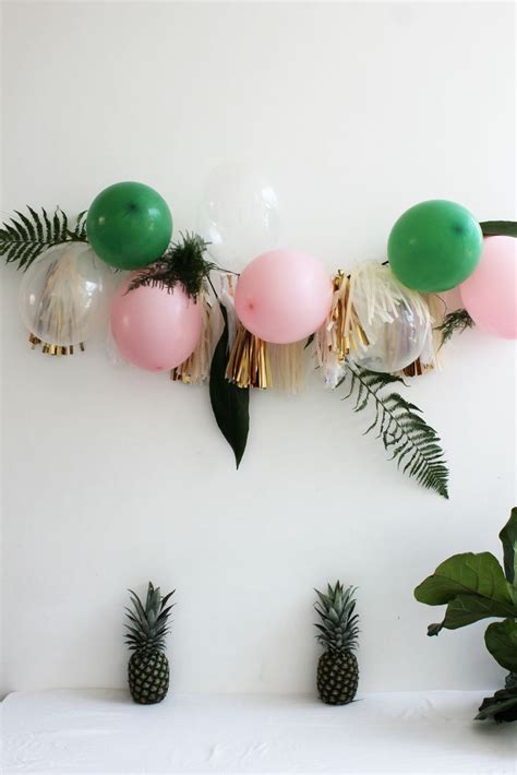 We'll help you get started with pool party ideas for decorations, food and beverages, activities and much more. tropical pineapple party with ferns / balloon garland in ...