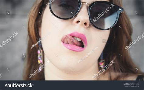 Стоковая фотография 1470299474 Sexy Lips Beautiful Woman Licks Her