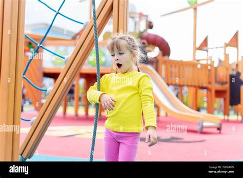 Cute Kid Girl Playing And Climbing On The Playground Stock Photo Alamy