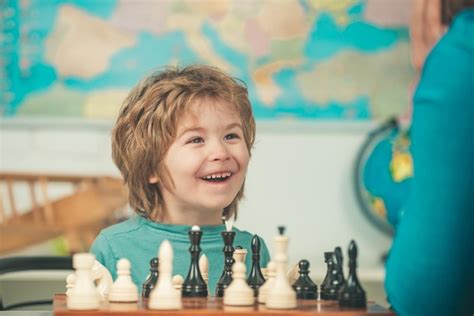 Premium Photo Young Kid Boy Playing Chess And Having Fun Cheerful