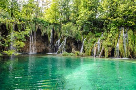 Big Waterfalls Over The Turquoise Waters Of The Lake In Plitvice