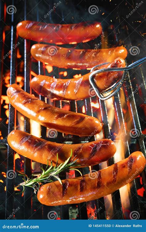 Delicious Sausages Sizzling Over The Coals On Barbecue Grill Stock