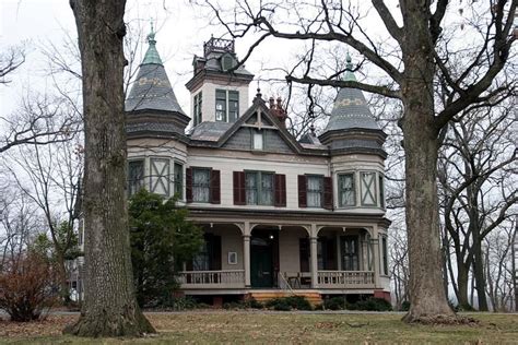 An Old Victorian Style House With Two Towers On The Front And Second