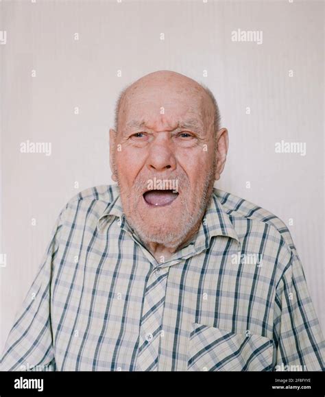 A Large Portrait Of An Old Man On A Light Background With Deep Wrinkles