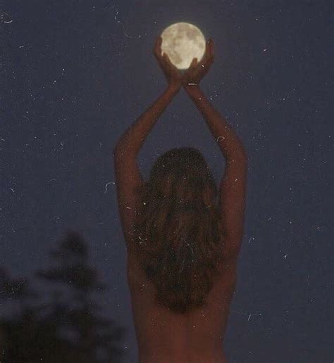 A Naked Woman Holding Up A Full Moon In The Night Sky With Her Hands Over Her Head
