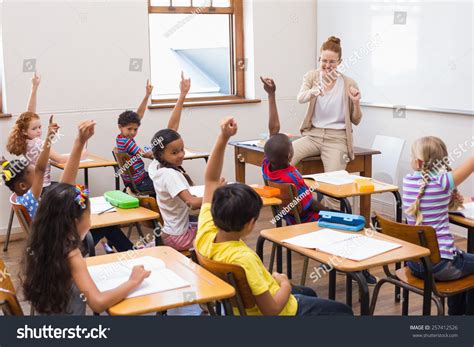 Pupils Raising Hand Classroom Elementary School Stock