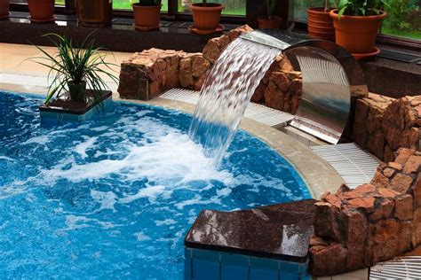 13 Beautiful Pool Waterfalls For Your Backyard Oasis