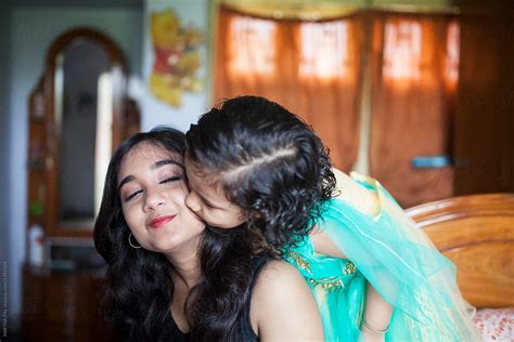 Mother And Daughter Kissing And Making Fun Inside Home Del