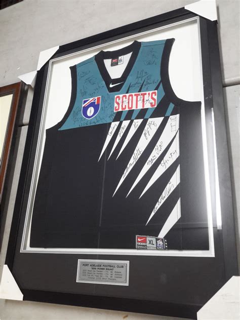 A fishing port is a port or harbor for landing and distributing fish. Box Framed Port Adelaide Football Club Jersey Signed From ...