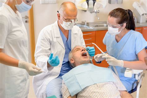 Senior Man At Dentist Surgery Having Tooth Operation Stomatology Clinic