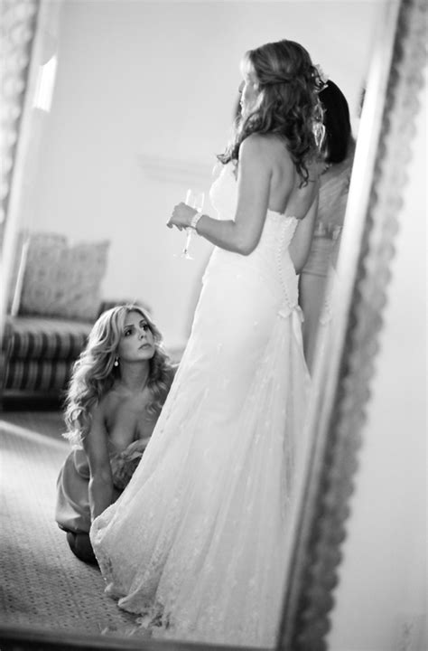 bridesmaid helps bride get ready