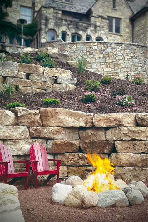 We installed a retaining wall fire pit with a surrounding wall for seating. Stone veneer lake home landscape design retaining wall ...