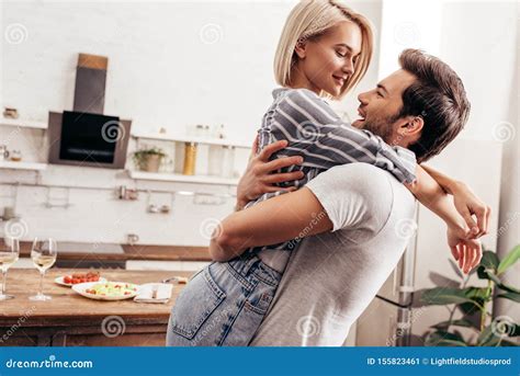 Handsome Boyfriend And Attractive Girlfriend Hugging And Smiling Stock