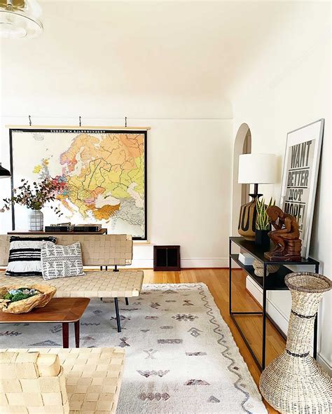 A Living Room Filled With Furniture And A Map On The Wall Above Its