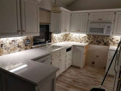 A slab backsplash is simply a backsplash made of a continuous material (or in cases like this one, a few large pieces with the occasional break for an appliance or a cabinet). Quartz Countertop and tile backsplash by T&T ...