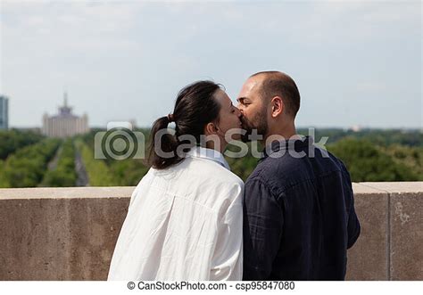 Romantic Couple Celebrating Relationship Anniversary Kissing On Tower Terrace Enjoying Spending