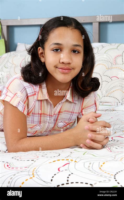 Girl Laying On Her Bed By Herself Stock Photo Alamy