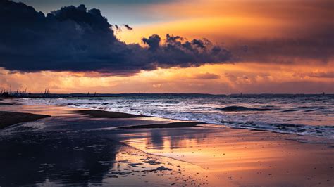 Sea Beach Waves Sand Under Black Clouds Sky During Sunset