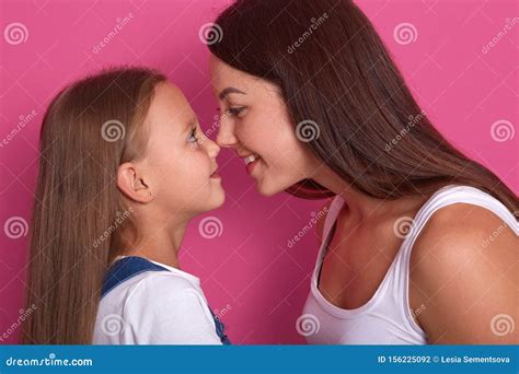 Close Up Portrait Of Beautiful And Happy Young Mommy And Small Daughter Looking At Each Other
