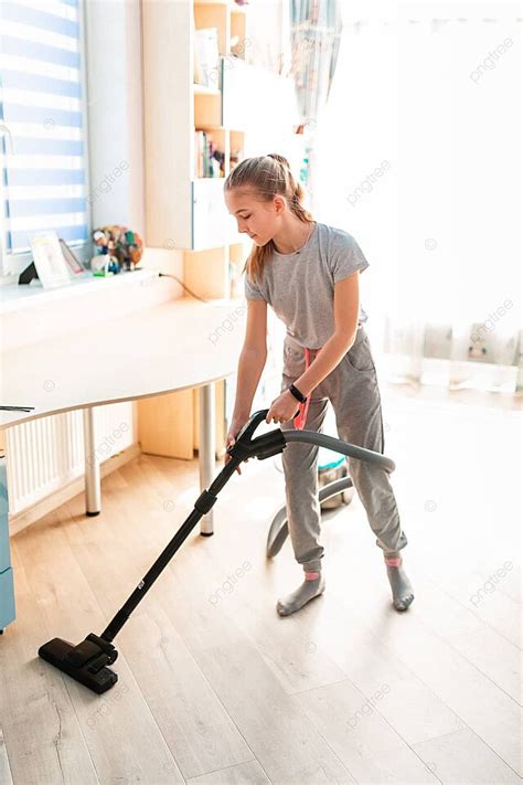 adolescent female using a vacuum cleaner to tidy her bedroom photo background and picture for