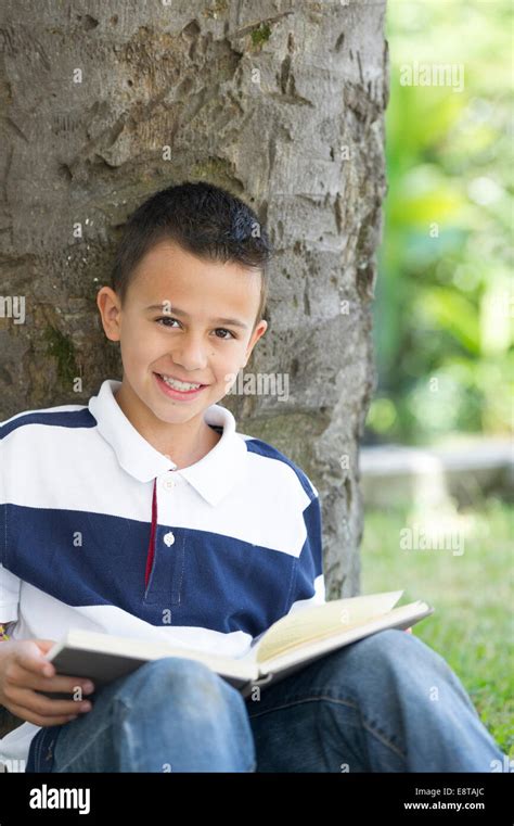 Hispanic Boy Reading Book Stock Photo Alamy