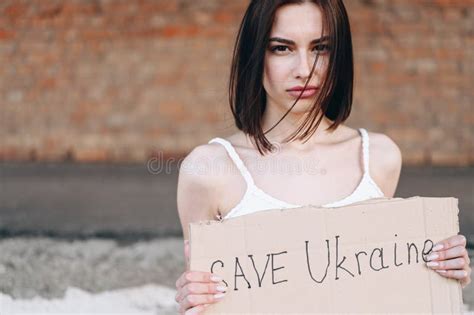 Girl With Poster In Her Hands Save Ukraine He Looks Sadly At Camera