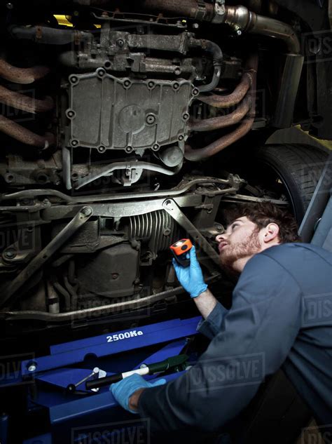 Male Mechanic Holding Torch Looking Under Car Stock Photo Dissolve