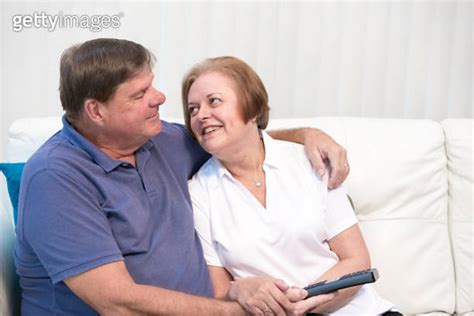 series senior tender moment married couple holding television remote control 이미지 641379014