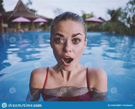 Surprised Woman With Wide Open Mouth Swimming In The Pool In A Red Swimsuit Cropped View Stock
