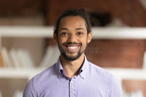 African Male Employee Head Shot Portrait In Modern Office Stock Image