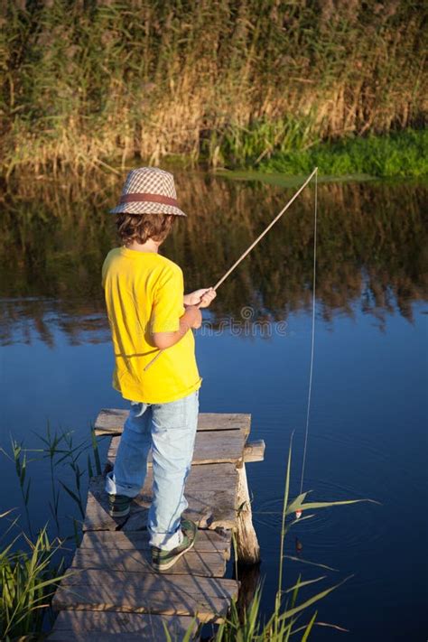 Happy Boy Go Fishing On The River One Children Fisherman With A Stock