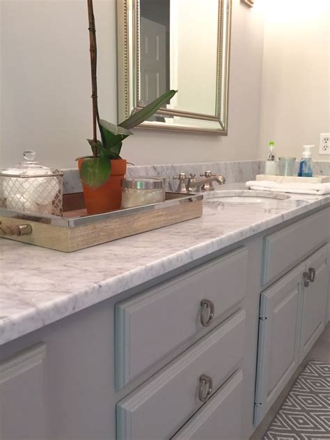 The first bathroom is soft and pretty, but was surprised that i couldn't find any of the paint names for the soft gray (?) cabinets or white walls when the whole piece was about bathroom paint choices! Carrera marble vanity top. New pulls. Painted vanity in ...