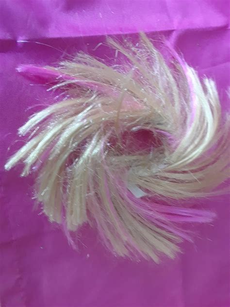 a friend was cleaning out her closet and found this it looks like barbie hair with teeny tiny