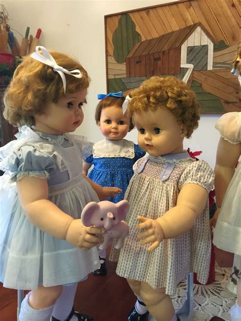 Three Dolls Are Standing Next To Each Other