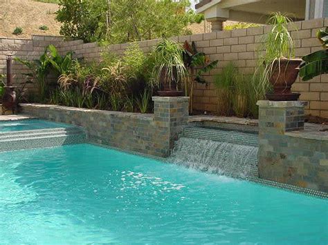 Typically, they send water cascading from above and flowing down the wall. Custom Swimming Pool Water Feature Design | Pool Ideas ...