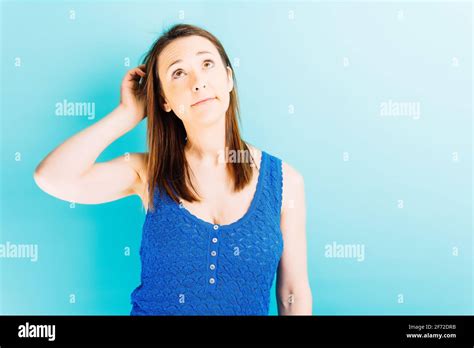 Beautiful Young Woman Scratching Her Head Looking Up Indecision Or