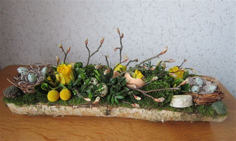 A Wooden Table Topped With An Arrangement Of Flowers And Plants On Top