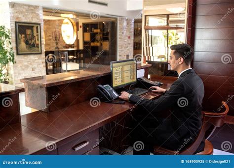 Front Desk Hotel Receptionist Working Stock Image Image Of Male Desk