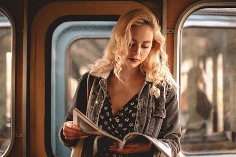 Young Woman Reading Magazine While Traveling In Subway Train Photograph