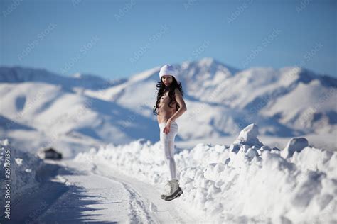 The Naked Girl On Snow Road To Mountains Stock Photo Adobe Stock