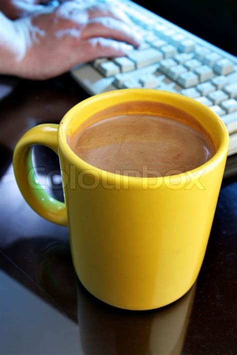 Si te gusta el sabor latino o conoces a alguien que lo haga, pide tu taza de café especial ahora. Yellow coffee mug and keyboard in the ... | Stock Photo ...
