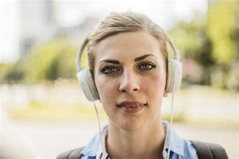 Portrait Of Confident Woman Wearing Headphones Stock Photo